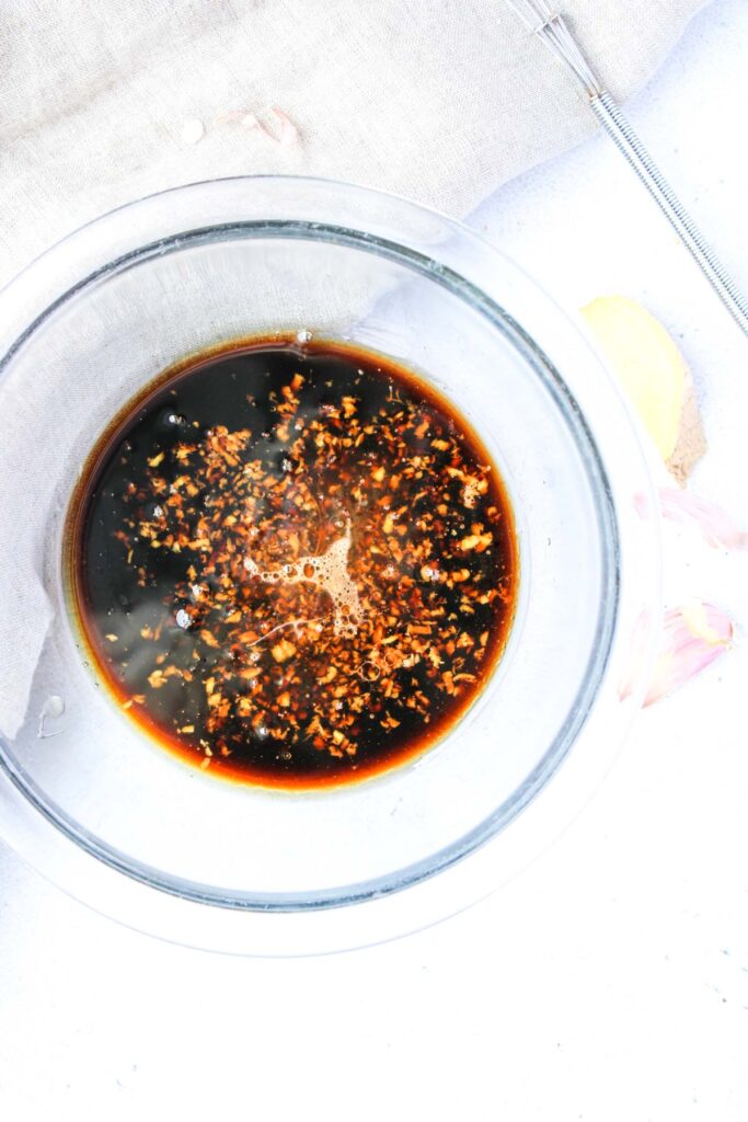 Honey and soy sauce marinade in a glass bowl.