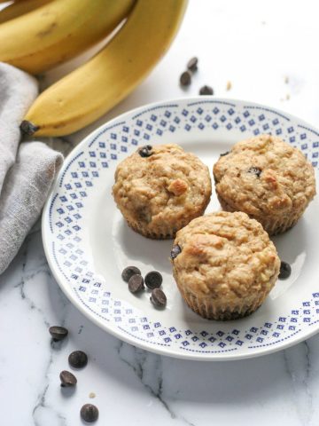 Three banana muffins on a white plate.