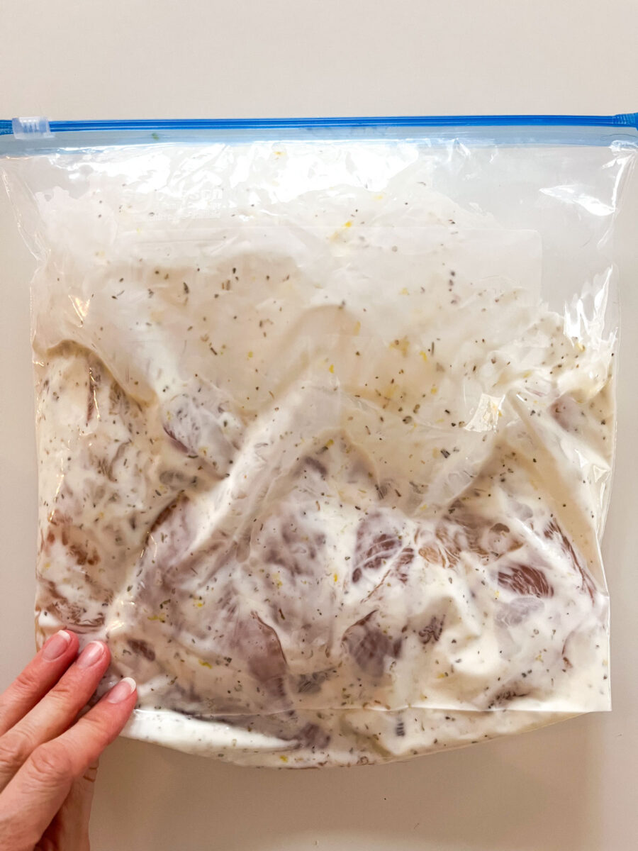 Turn and massage bag to coat chicken in marinade.