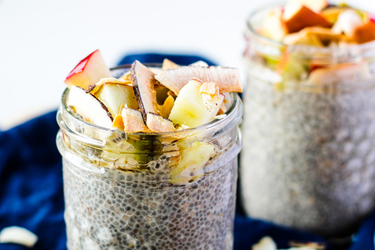 Two jars of chia Pudding seed pudding topped with apple chunks