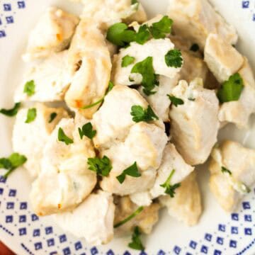 Tzatziki Chicken Breasts bites on a white plate.