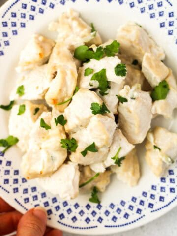 Tzatziki Chicken Breasts bites on a white plate.