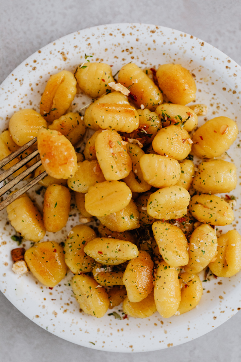 Gnocchi on a plate with a fork.
