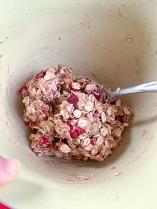 bowl filled with oats and peanut butter with raspberries